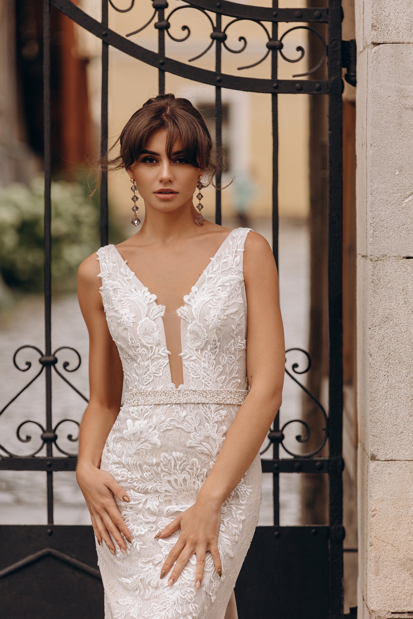 Mermaid gown with fitted lace bodice, low V-neckline, and elegant silhouette