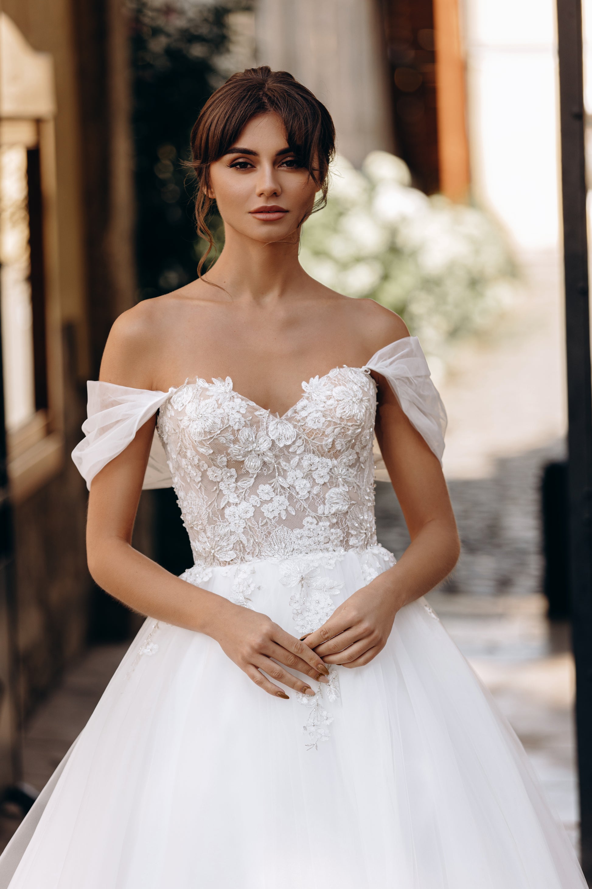 Romantic gown with off-shoulder neckline and voluminous tulle skirt
