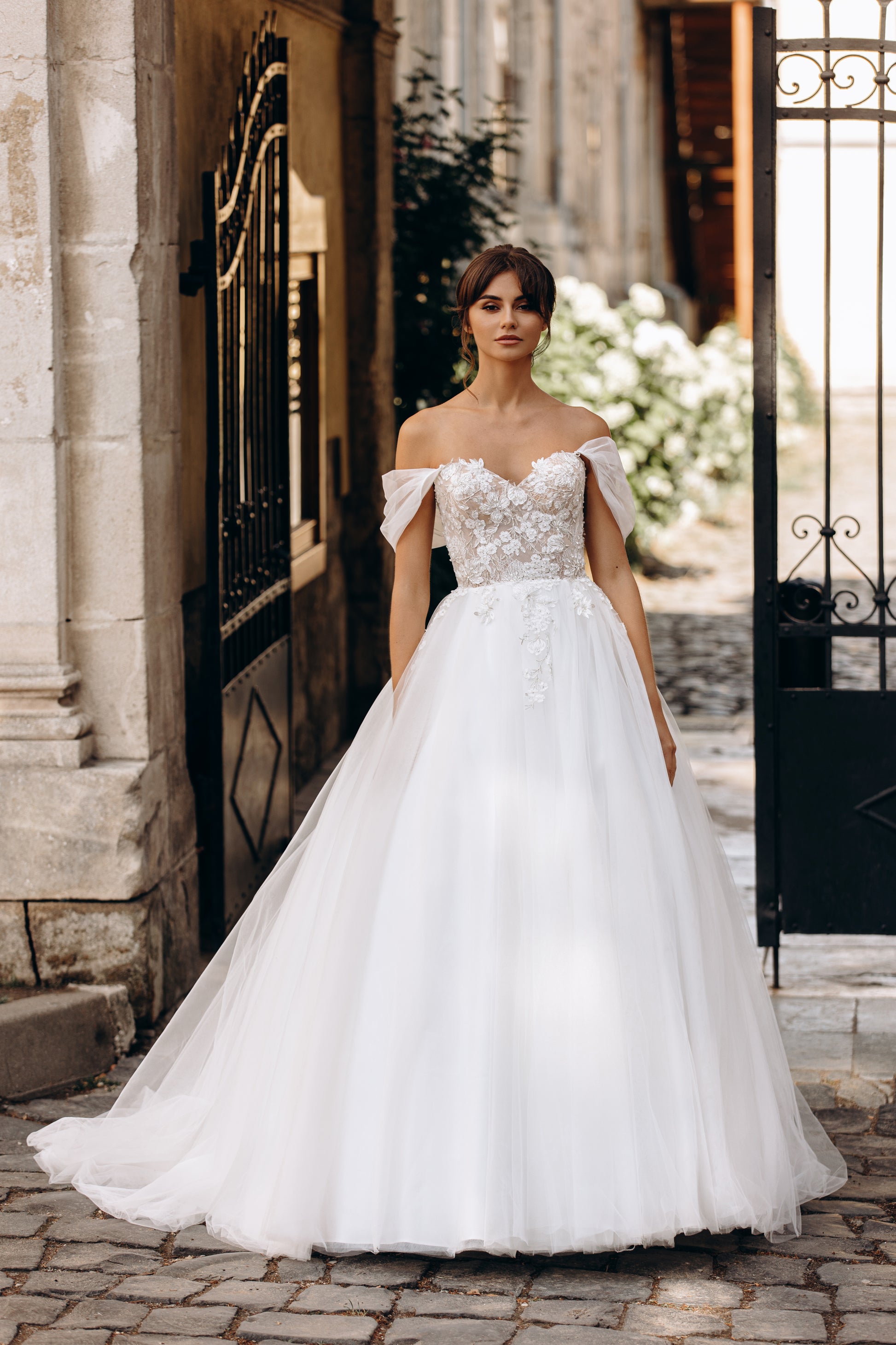 Bride in ball gown wedding dress with floral embroidery and tulle skirt
