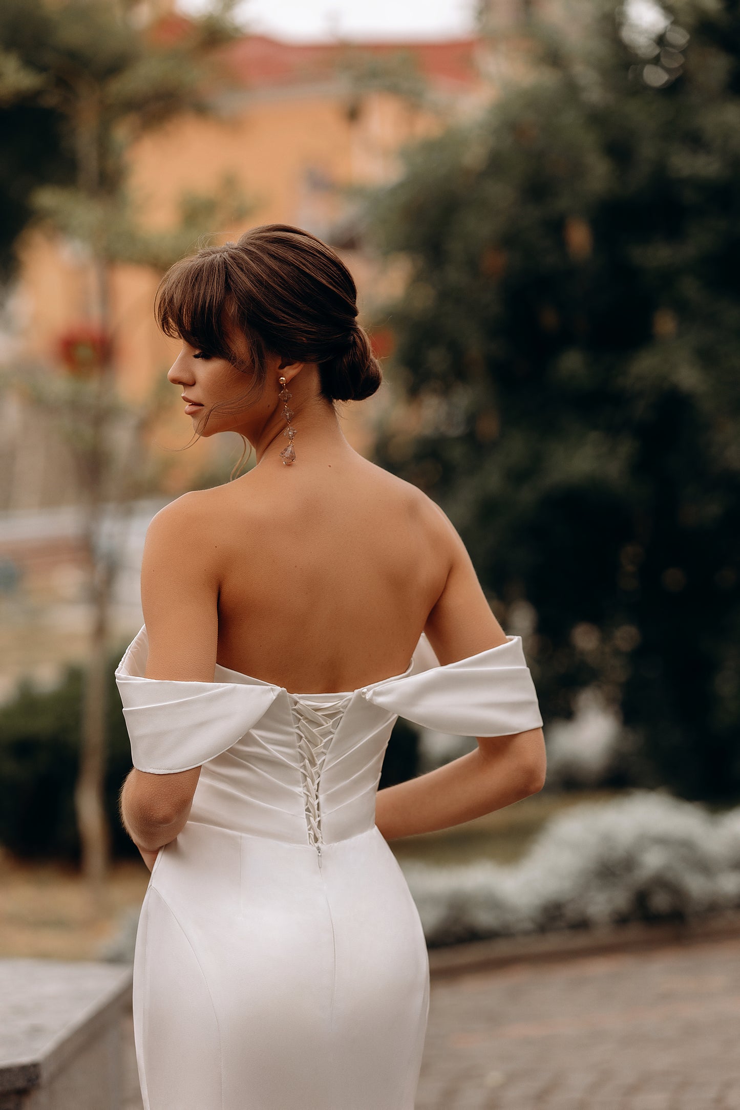 Bride in mermaid dress with a low back and train detail