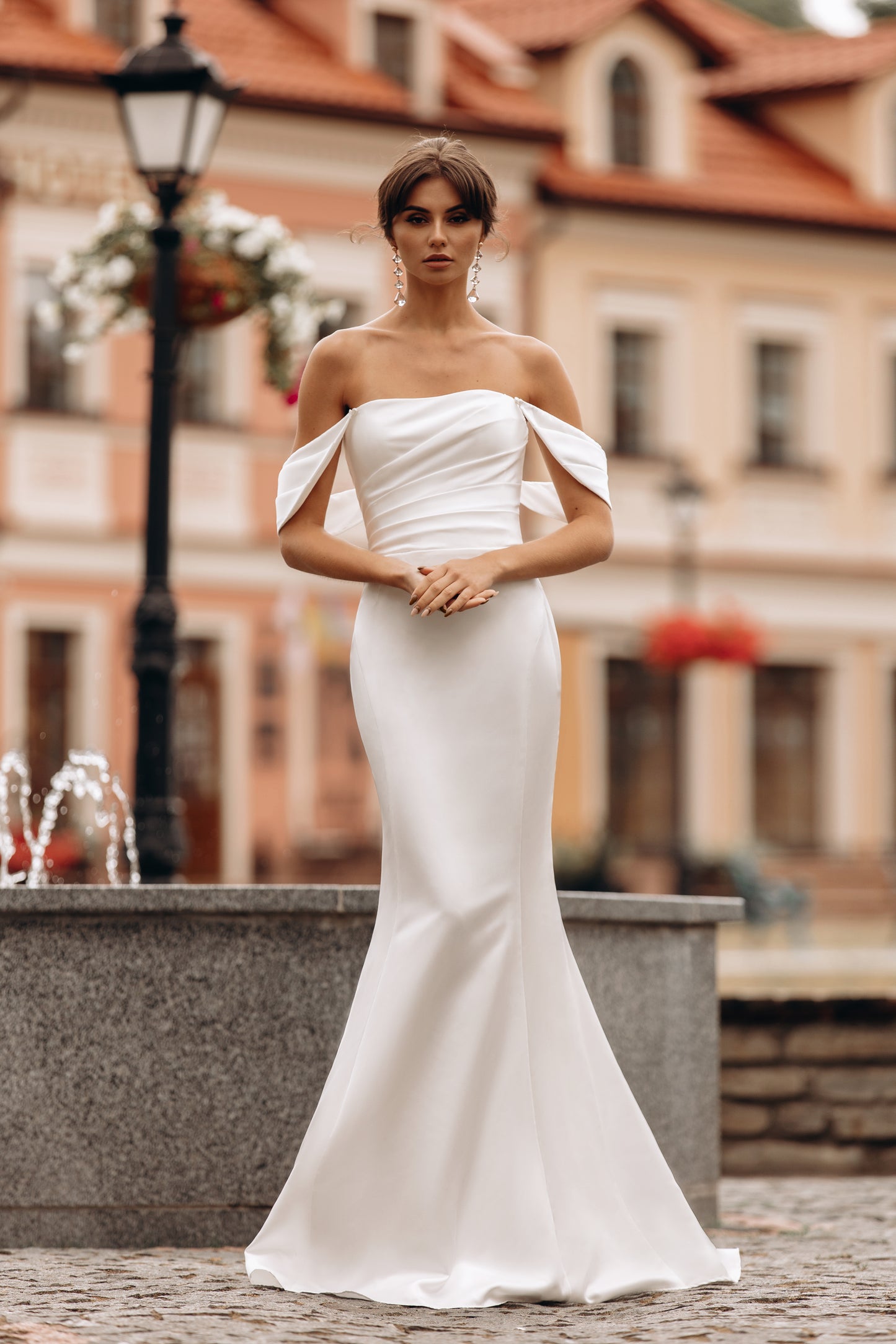 Bride in a sleek off-shoulder mermaid gown with flared hem