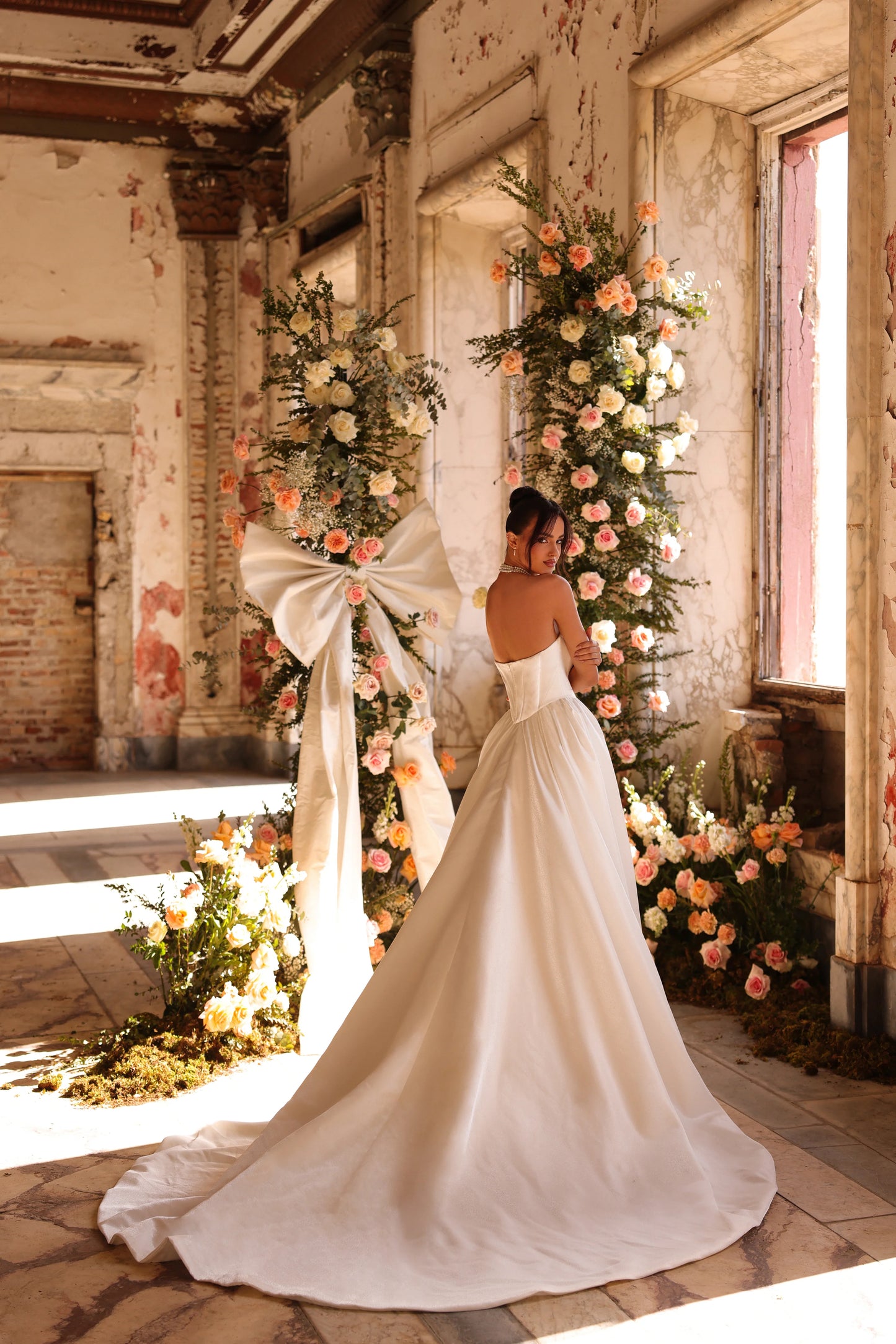 Minimalist wedding gown with romantic train cascading from fitted silhouette