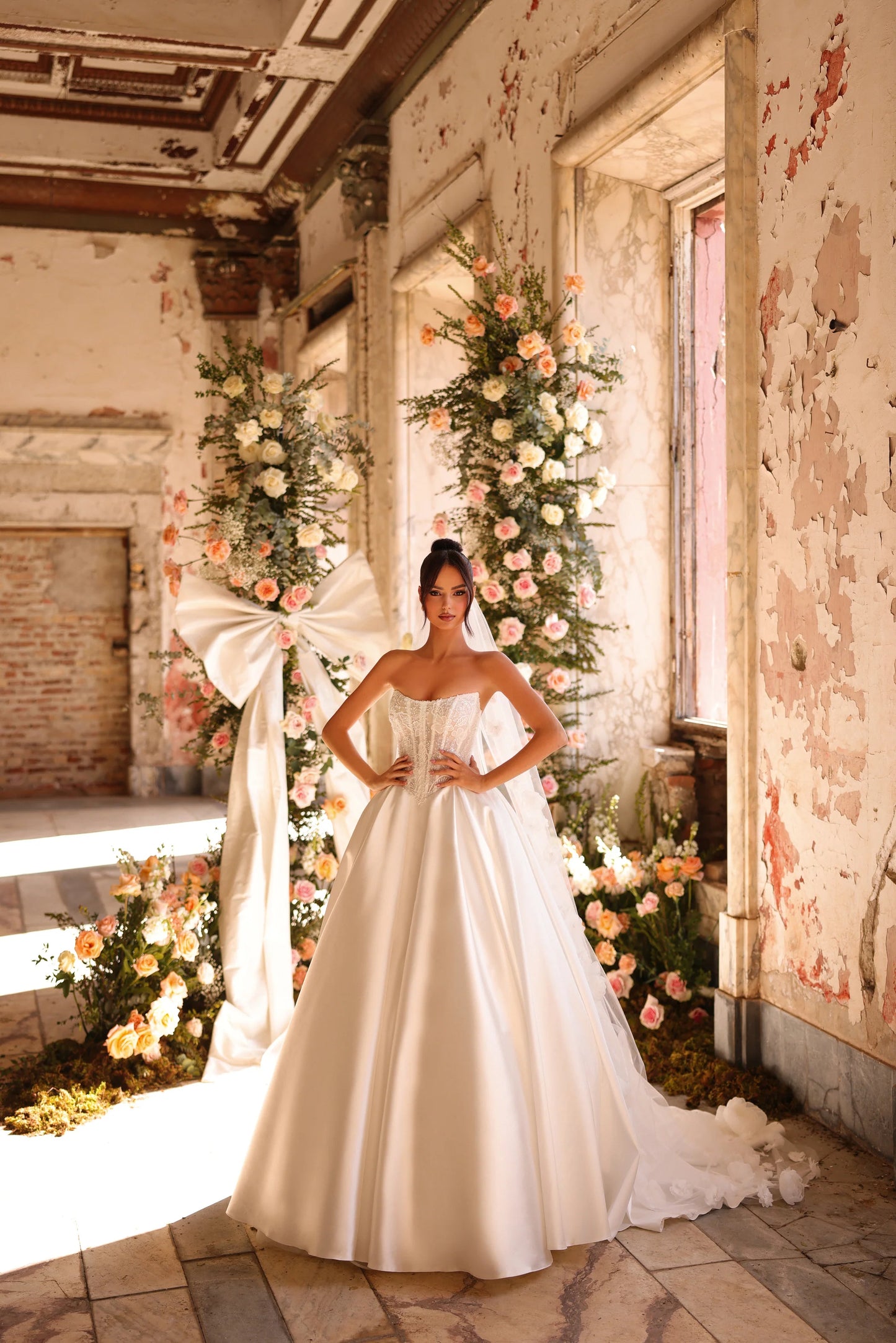 Bride in sculpted corset gown with full satin skirt and flowing train