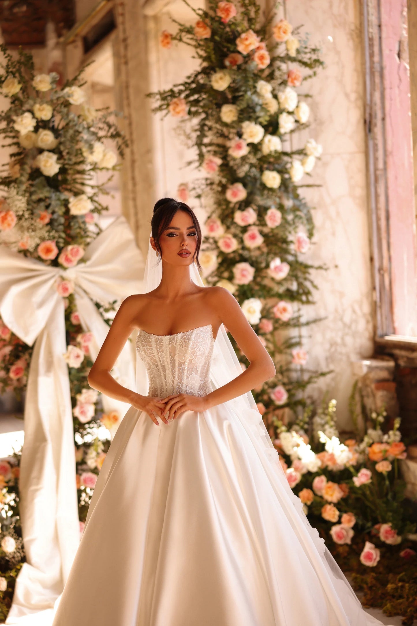 Fairytale gown framed by floral archway and natural light