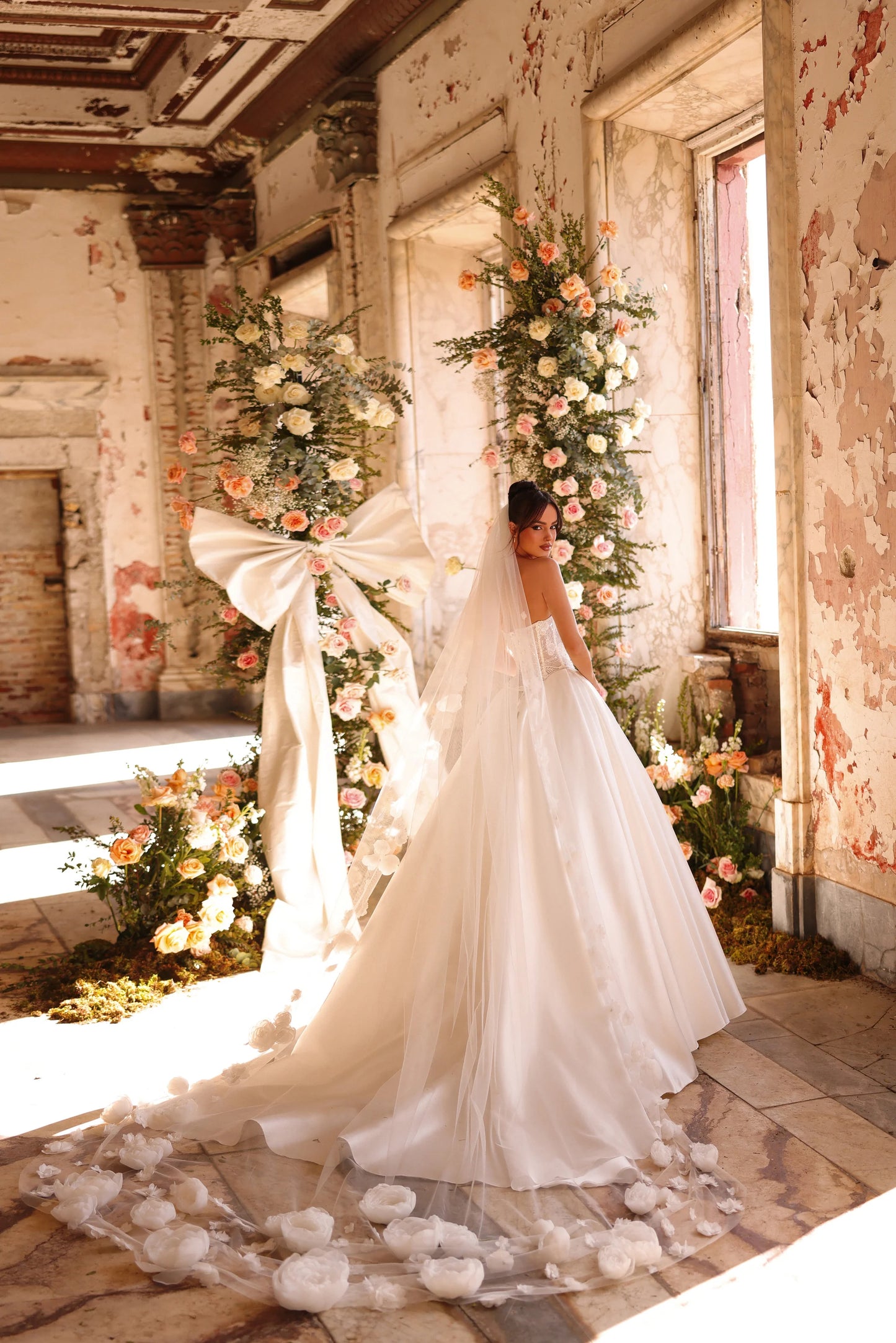 Flowing train and grand veil create a magical, timeless bridal look