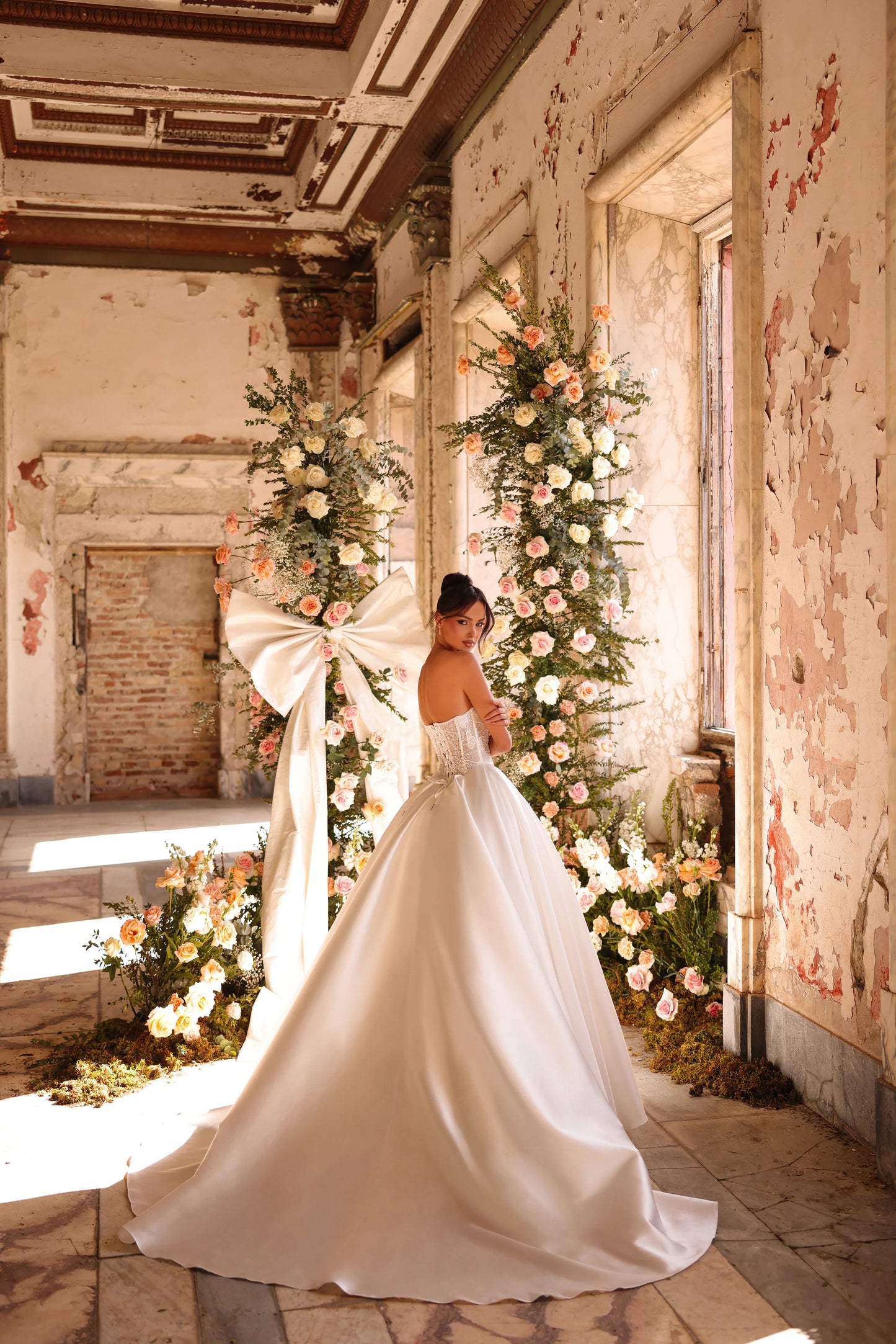 Bride gliding in dramatic satin gown with cathedral-length veil
