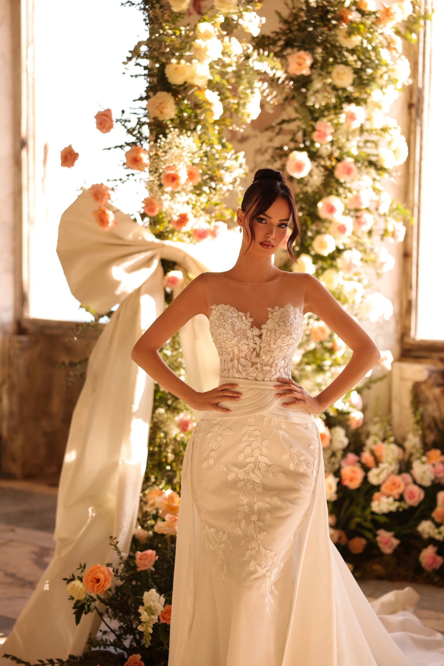 Bride in dramatic train that flows from illusion bodice – elegant and modern