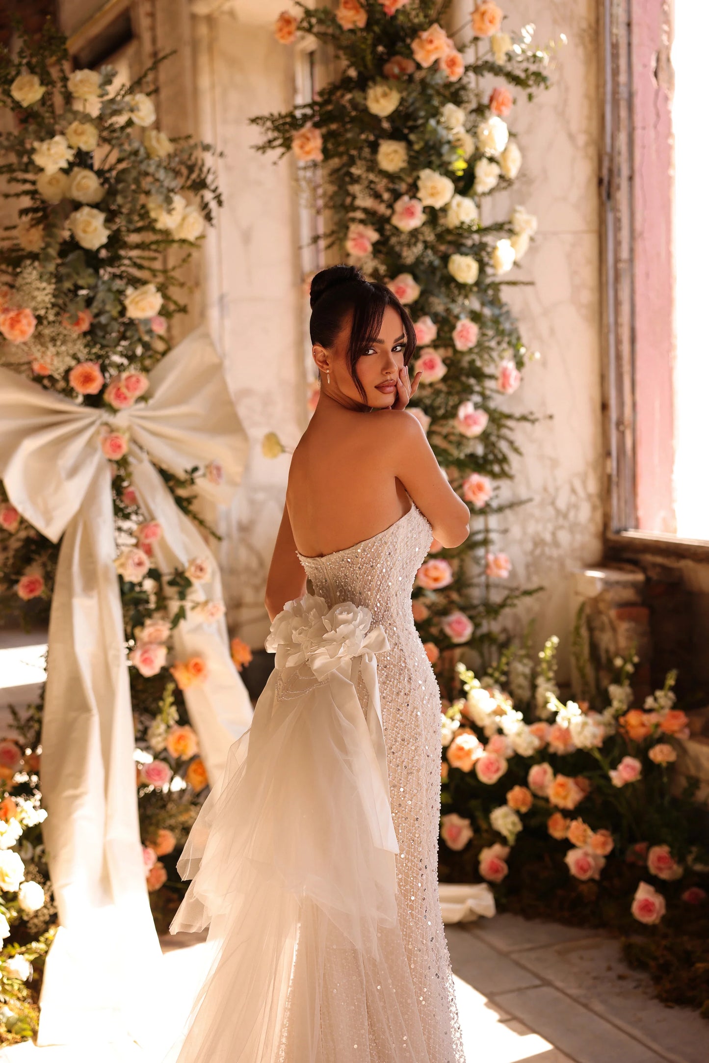 Elegant bridal dress with dramatic tulle bow and sparkling details