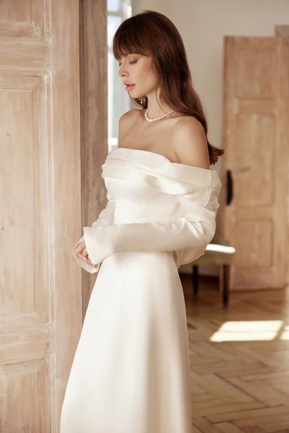Modern romantic look in ivory silk gown with timeless drape and movement