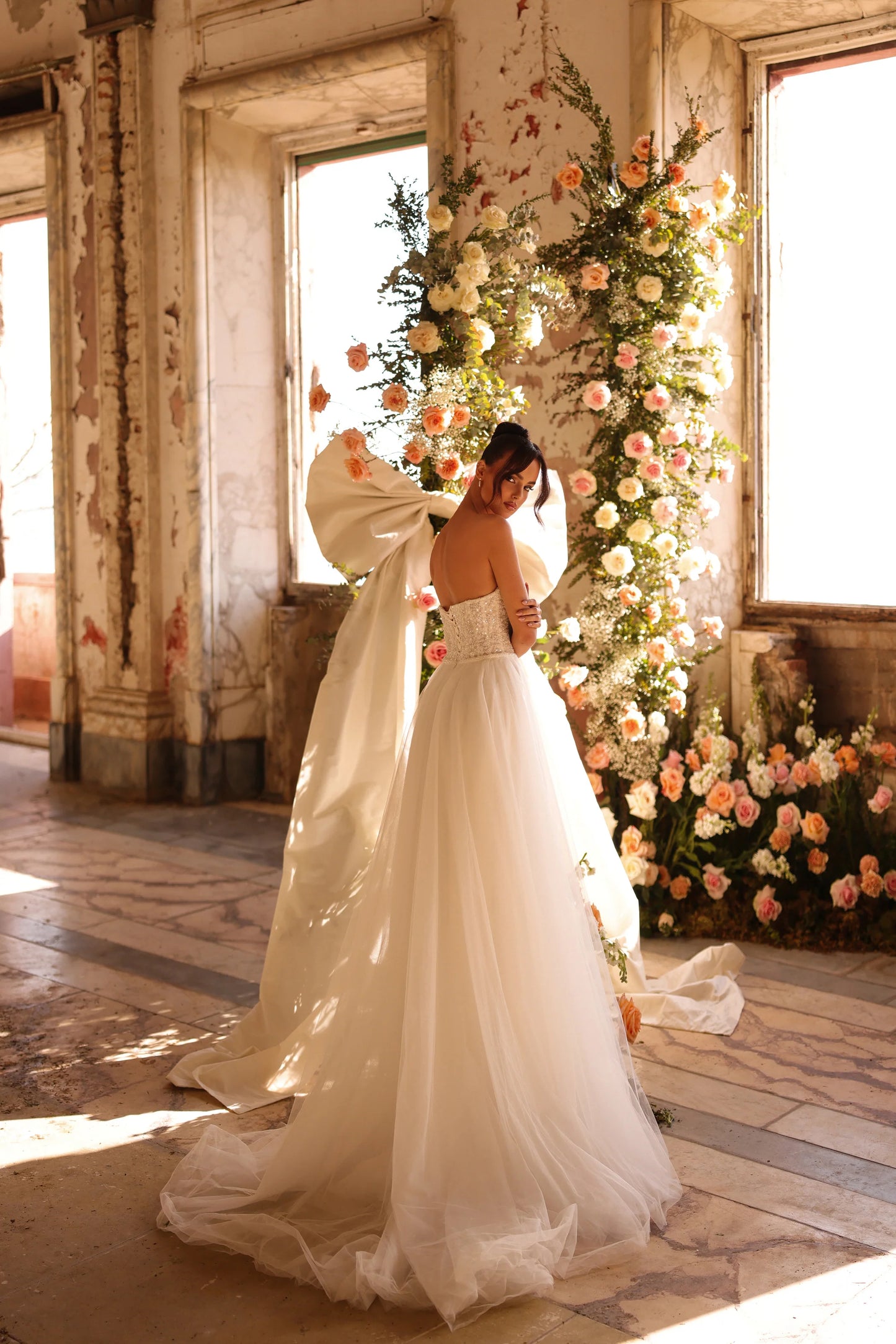 Romantic bridal gown with light flowing layers and delicate sleeve details