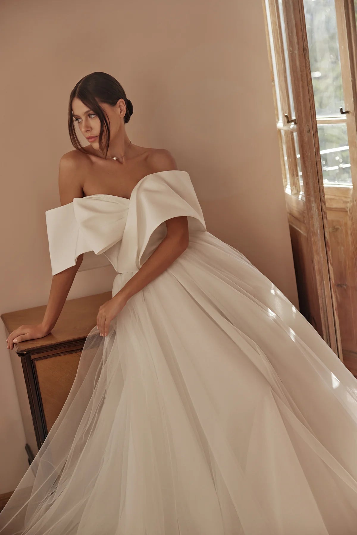 Bride in flowing gown, looking to the side