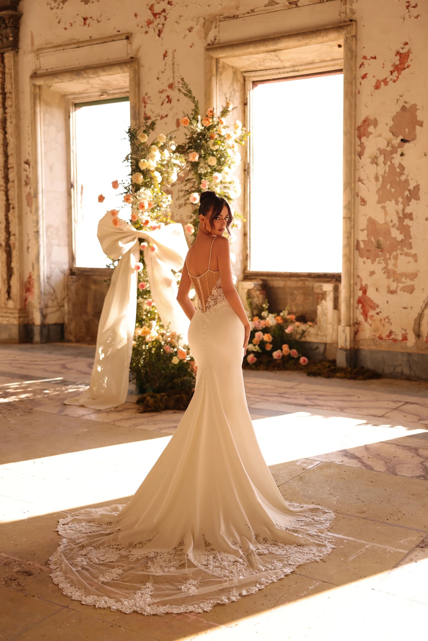 Minimalist bridal gown with detailed lace and timeless silhouette
