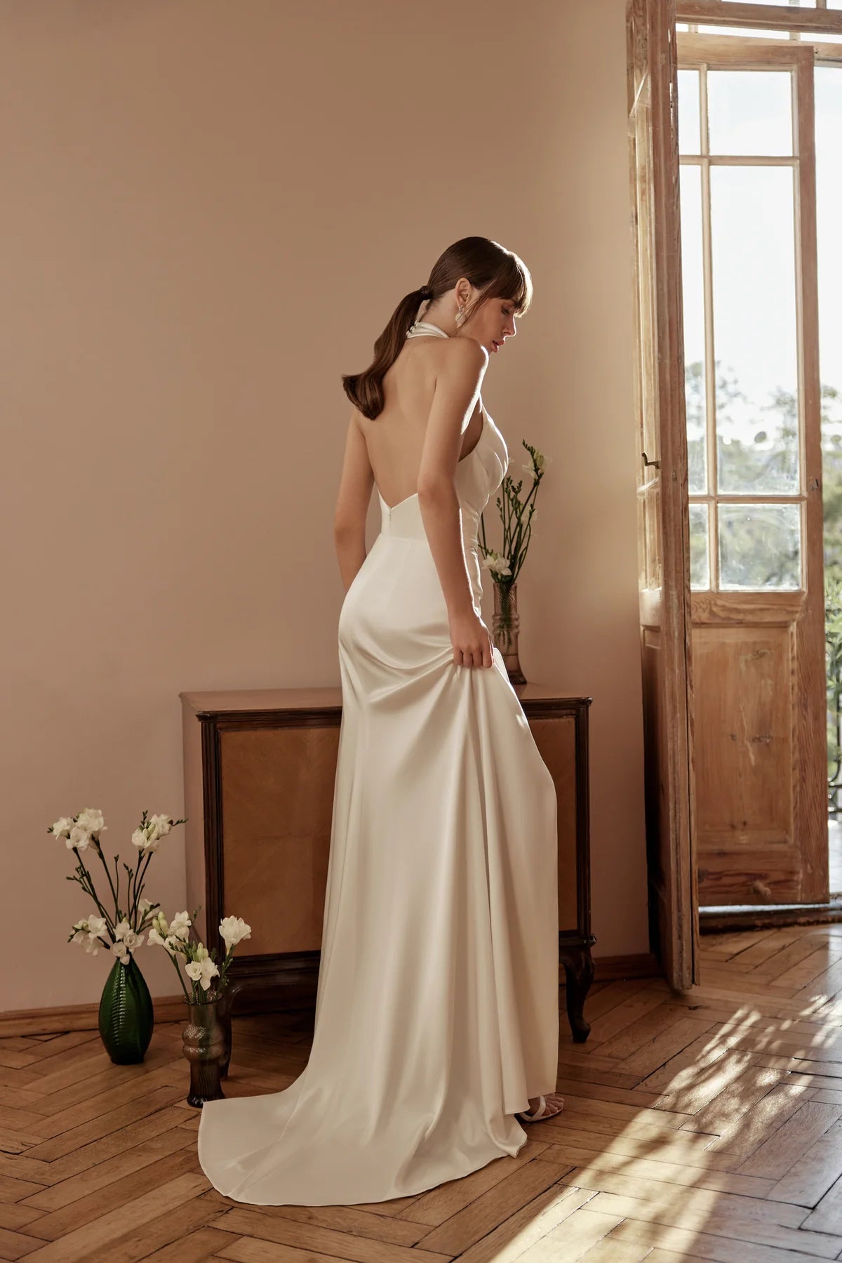 Back view of sheath wedding dress with satin finish and lace bodice
