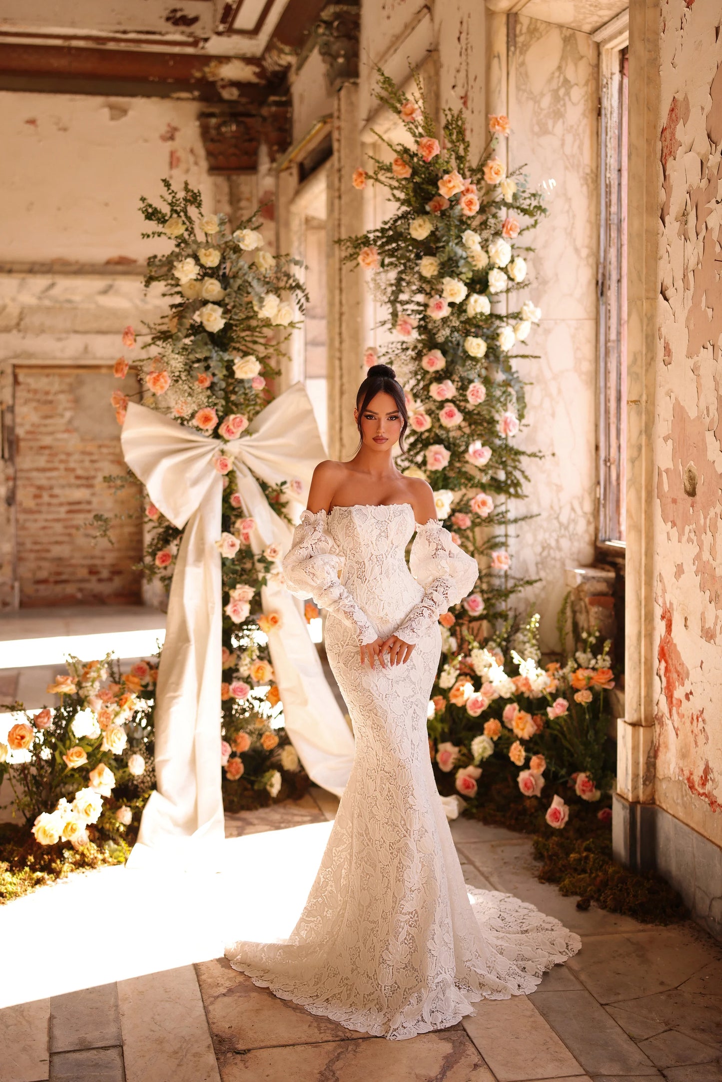 Bride in off-shoulder lace gown with puff sleeves and sweeping train