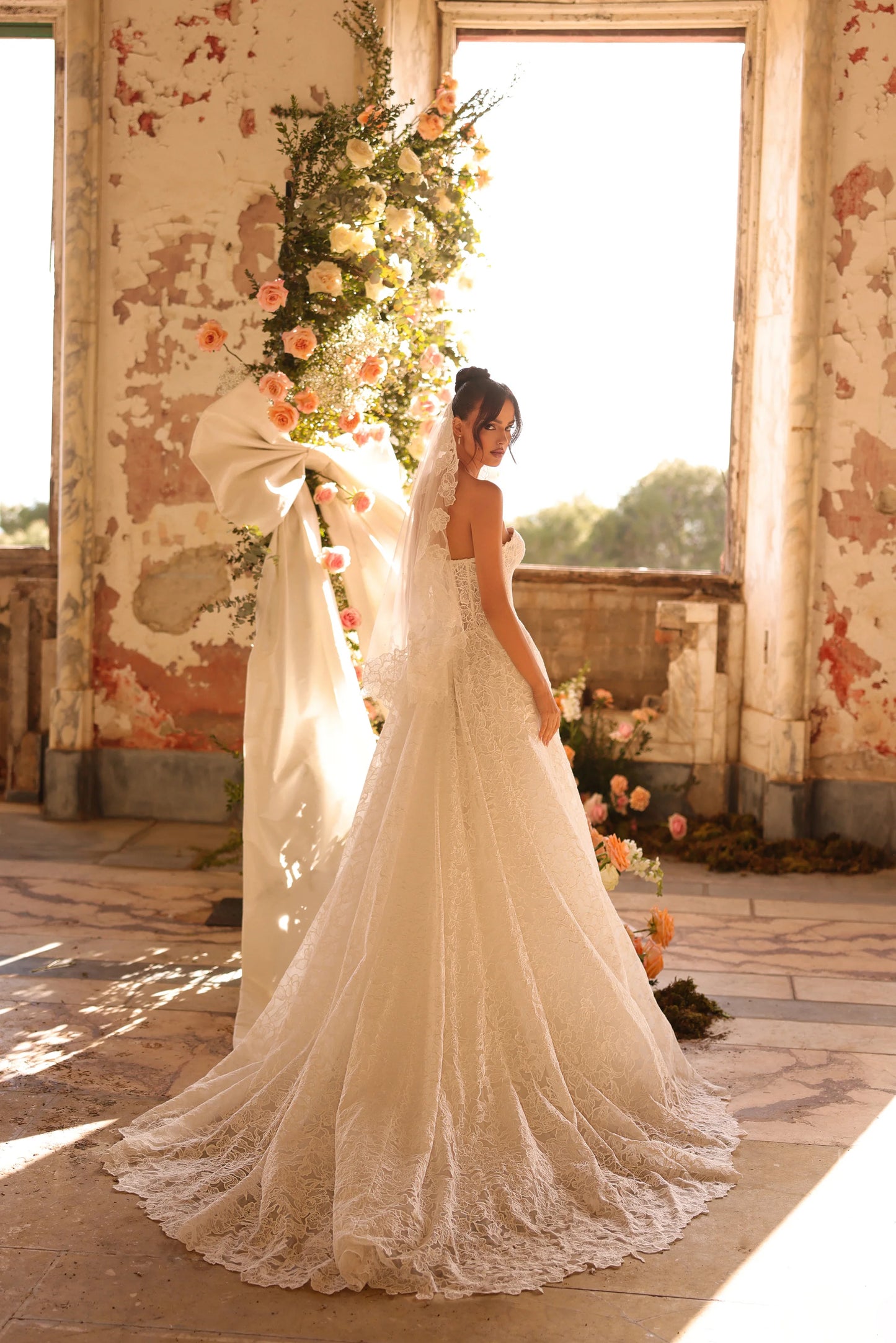 Romantic gown with corset bodice and flowing skirt in floral setting