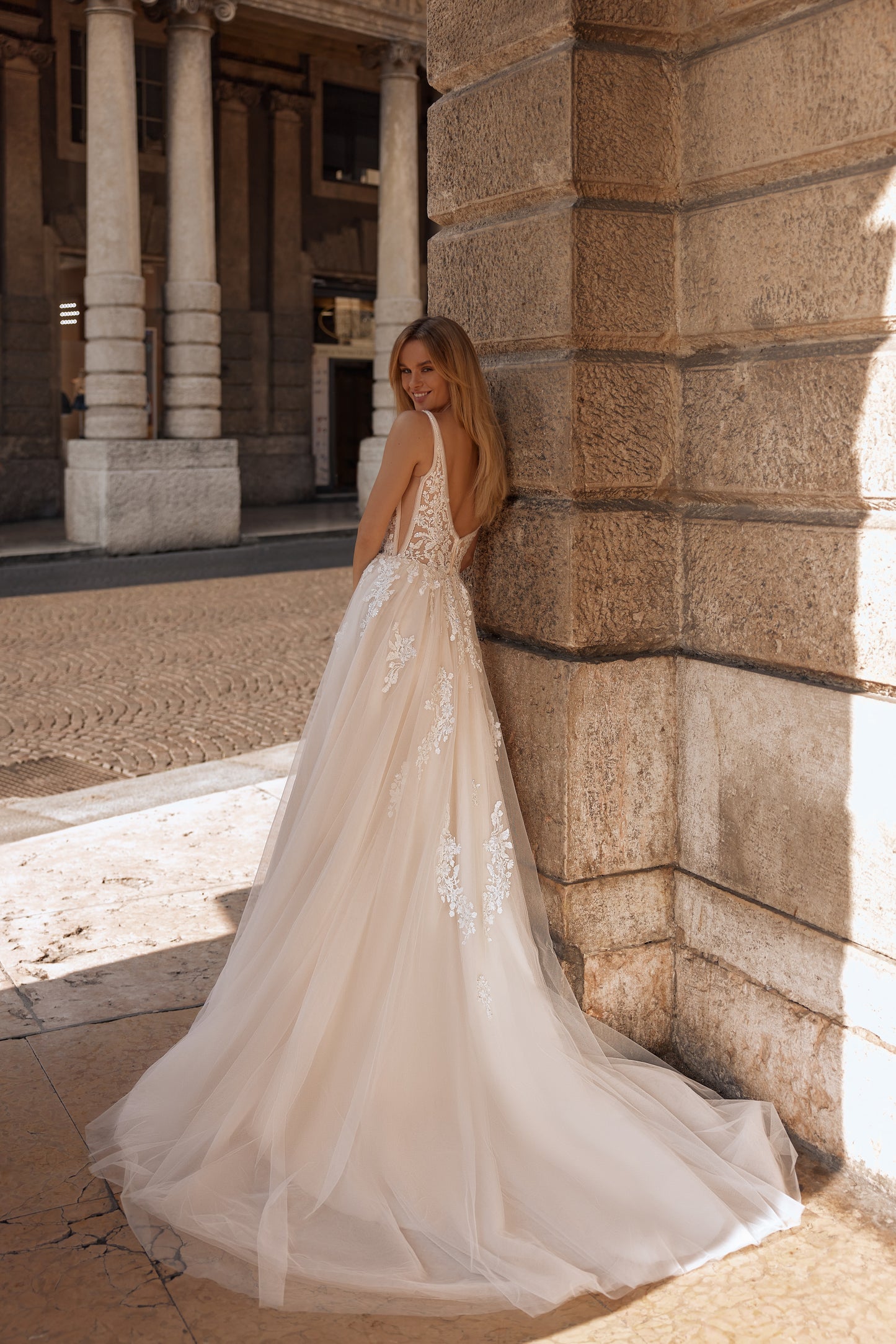 Long-train gown with floral lace details and fitted silhouette