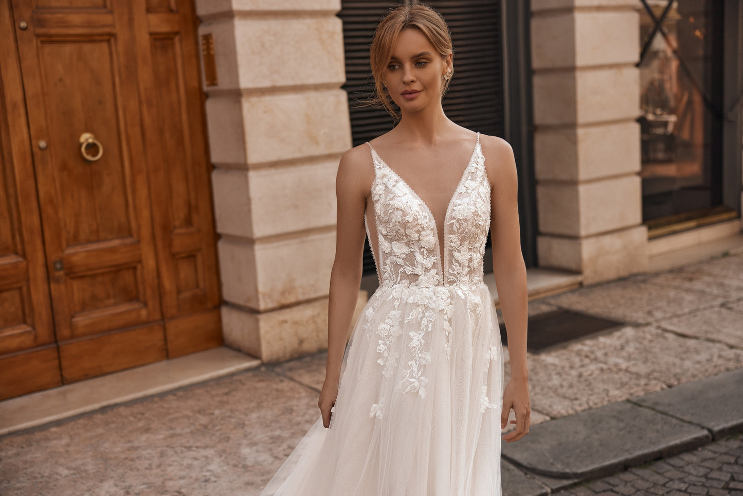 Bride in lightweight dress with floral lace top and thin shoulder straps