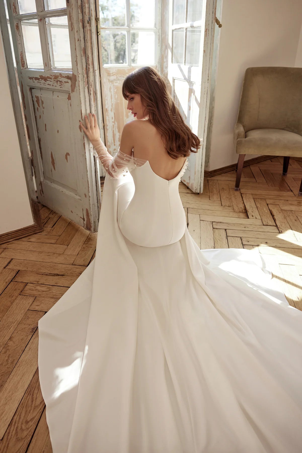 Bride walking in the dress, showcasing the flowing skirt and sophisticated design.