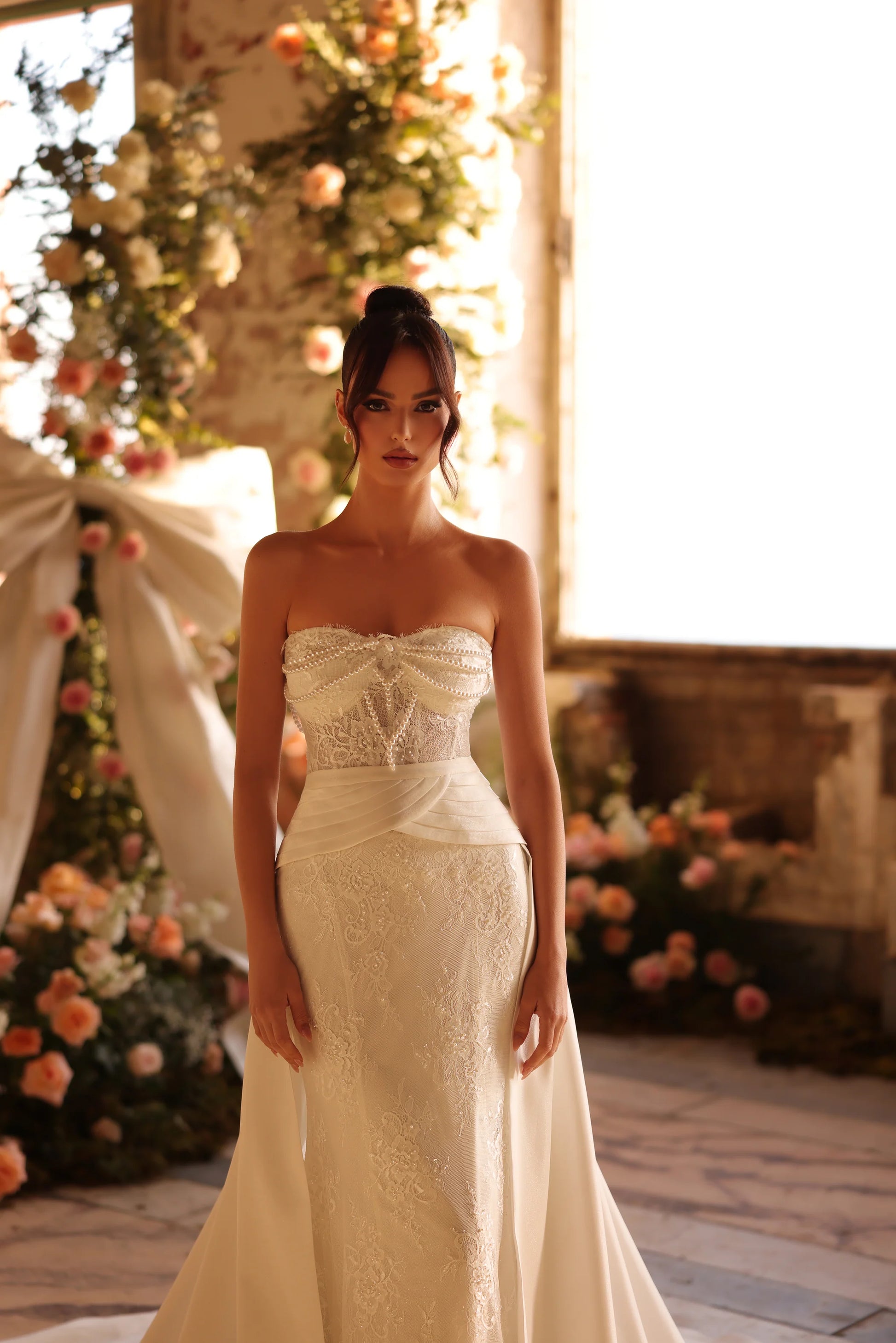 Detailed view of fitted bodice with floral lace and soft pleating