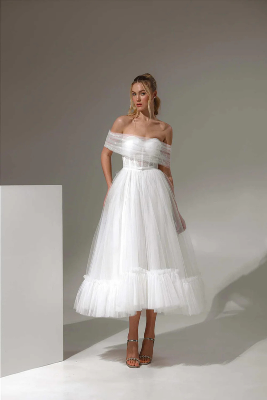 Tea-length ivory wedding dress with corset bodice and off-shoulder tulle detail