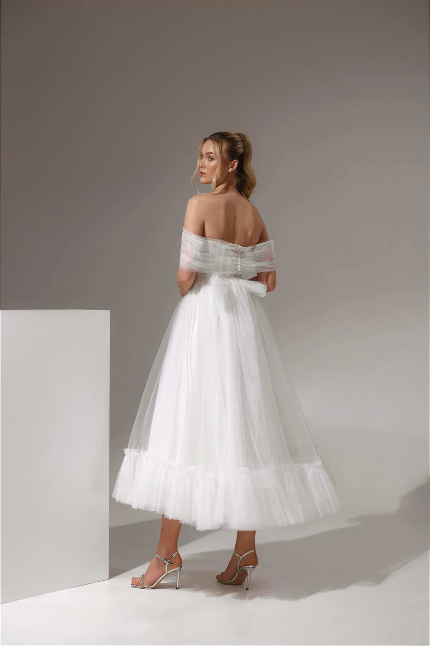 Modern midi wedding dress with airy tulle skirt and gathered hem