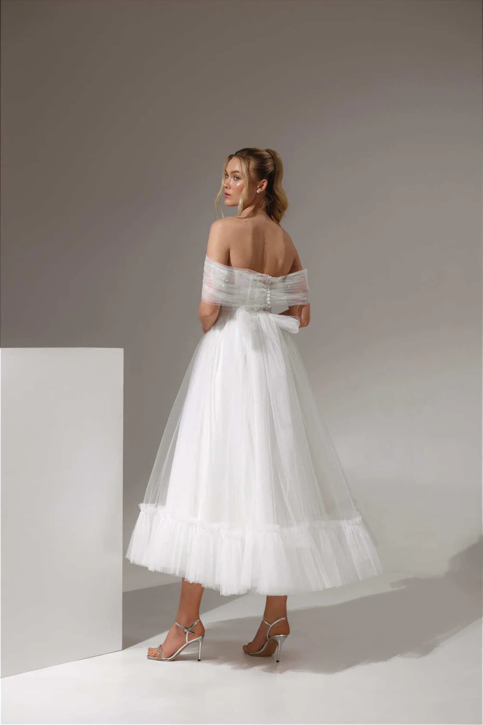 Modern midi wedding dress with airy tulle skirt and gathered hem