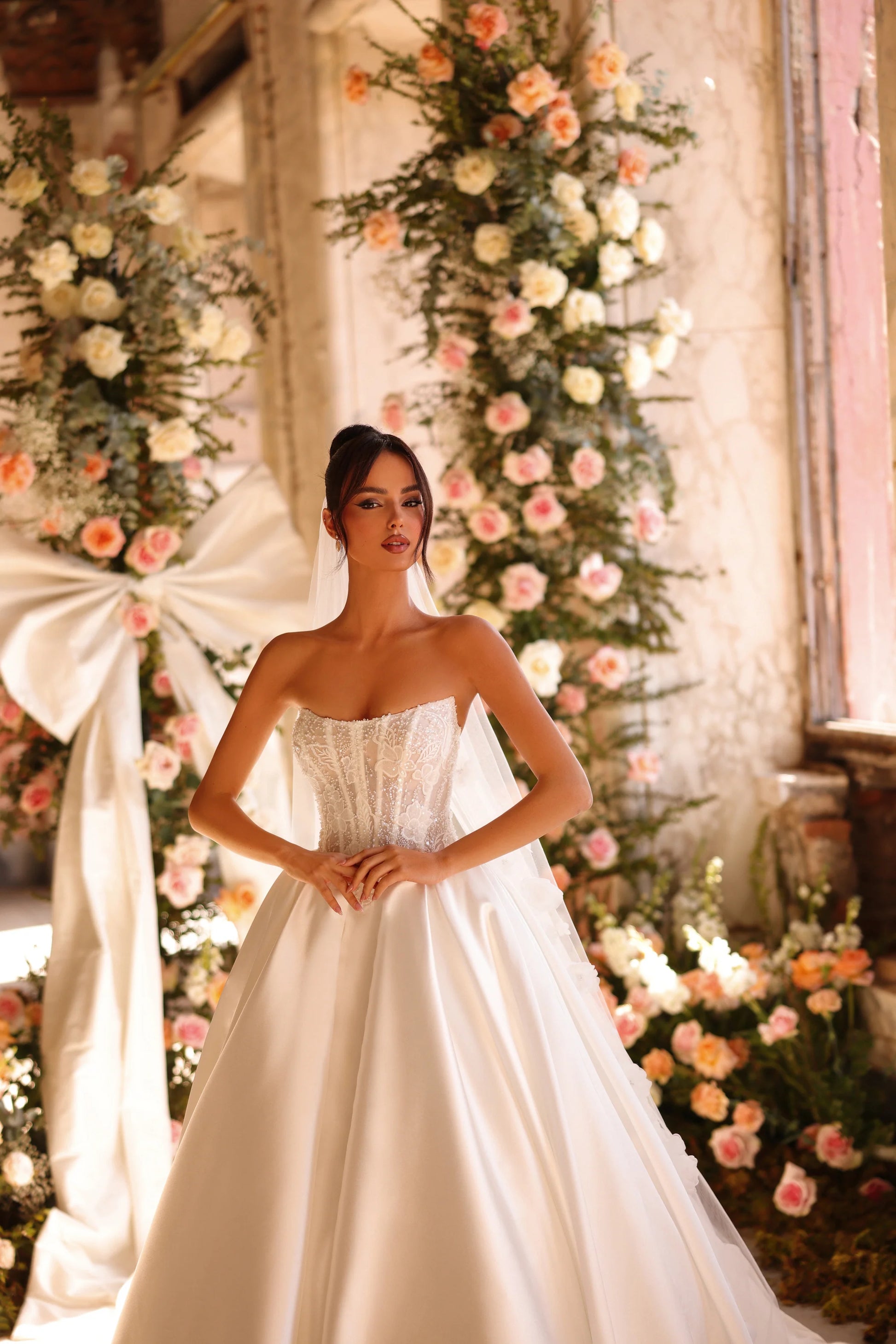 Fairytale gown framed by floral archway and natural light