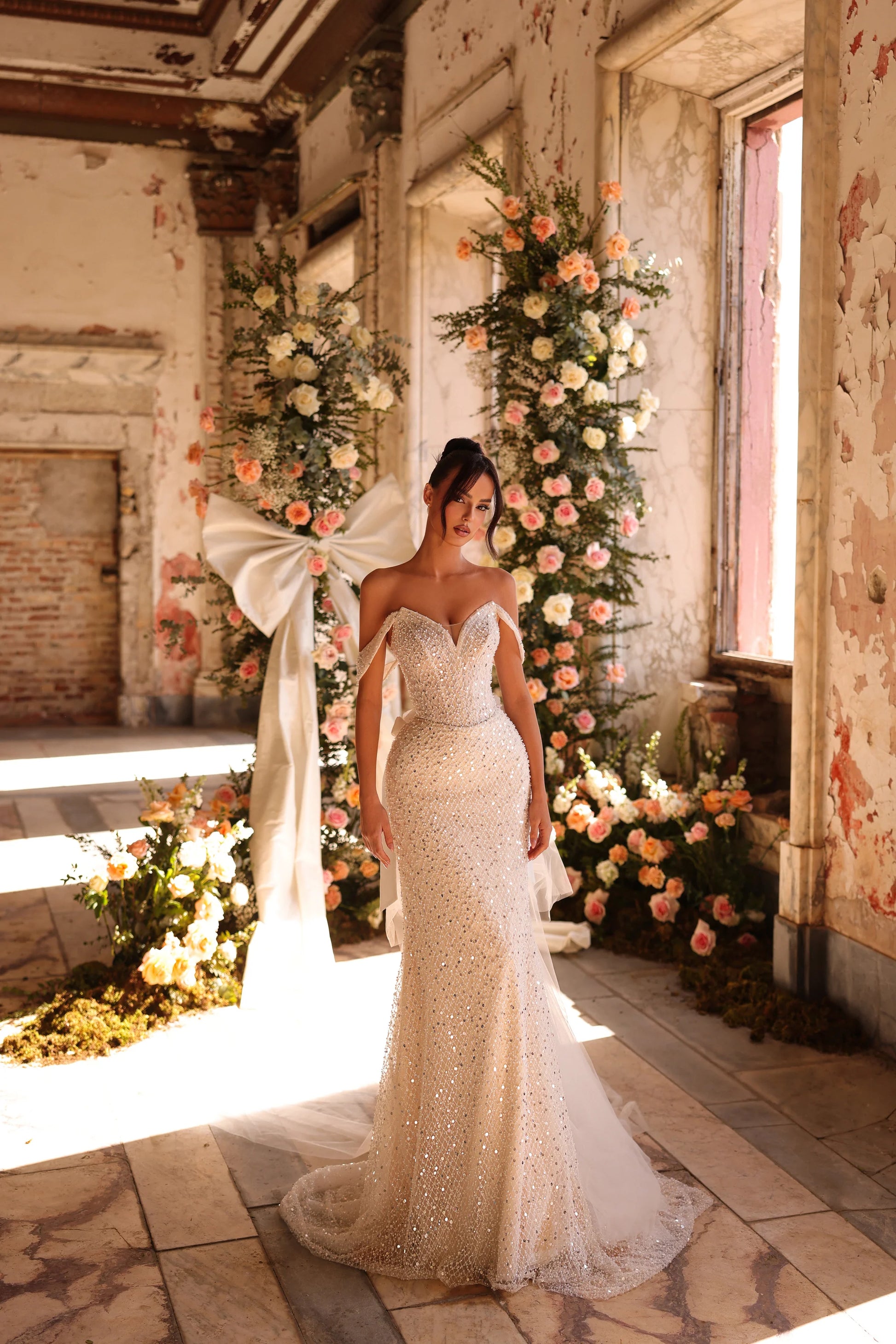 Bride in shimmering beaded wedding gown with sculpted silhouette and bold presence