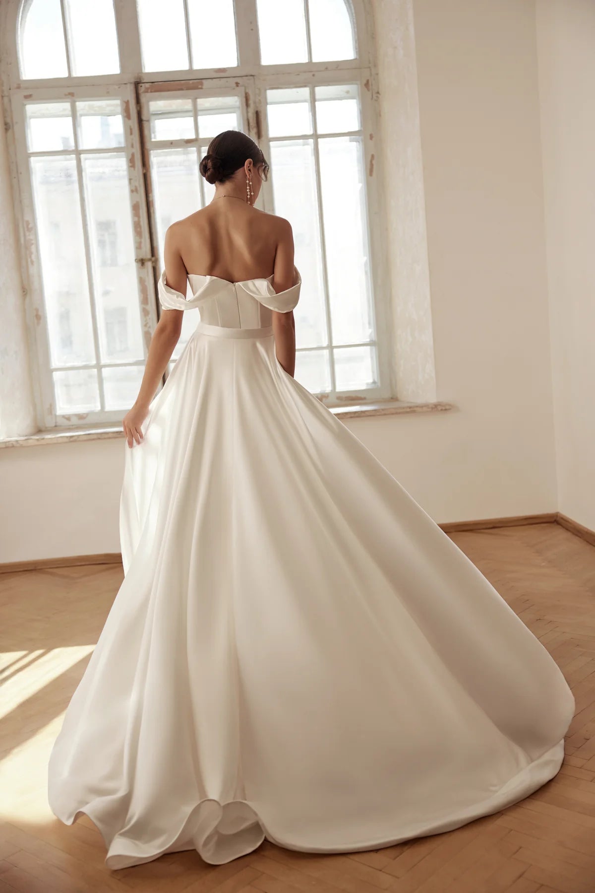 Bride twirling in the gown, showing the flow and side slit.