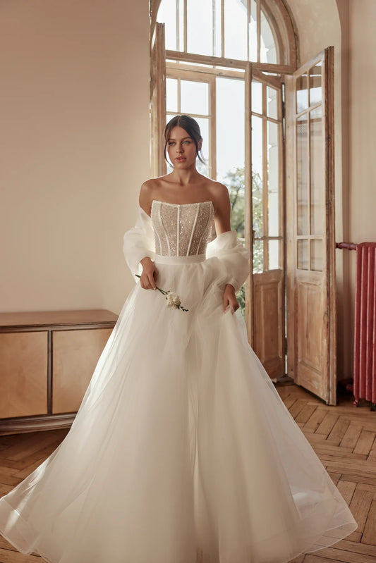Bride in a sparkling ball gown with an off-shoulder bodice and flowing tulle skirt