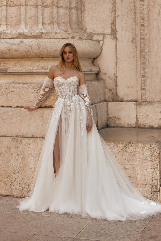 Bride in strapless A-line wedding gown with lace bodice and flowing tulle skirt