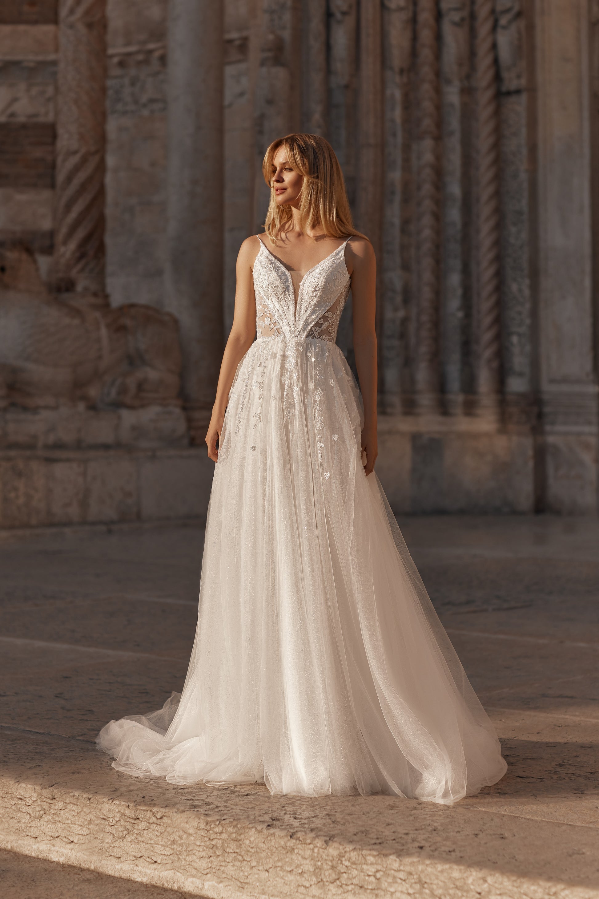 Bride in airy tulle gown with floral corset and flowing A-line skirt