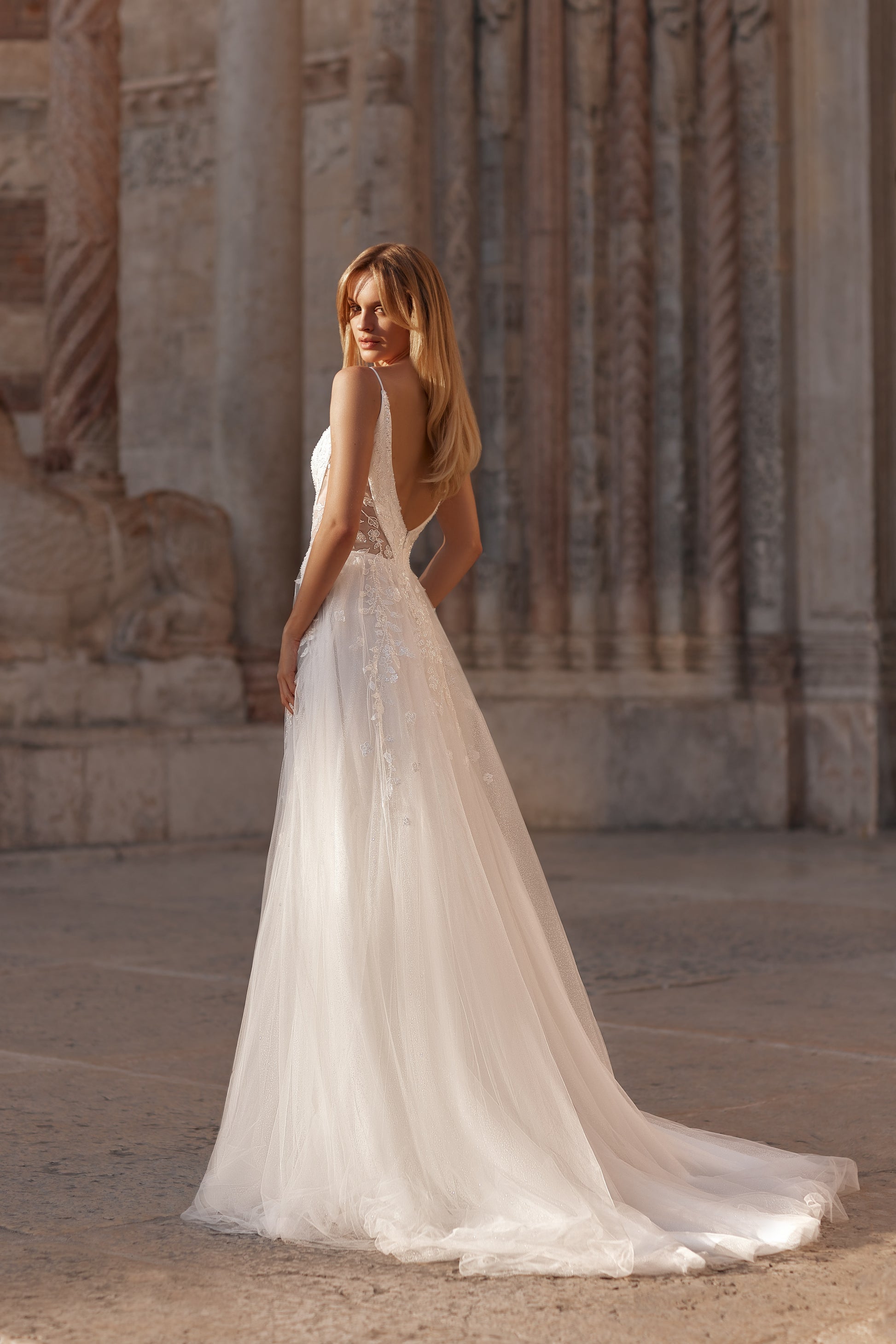 Romantic open-back wedding dress with layered tulle and soft movement