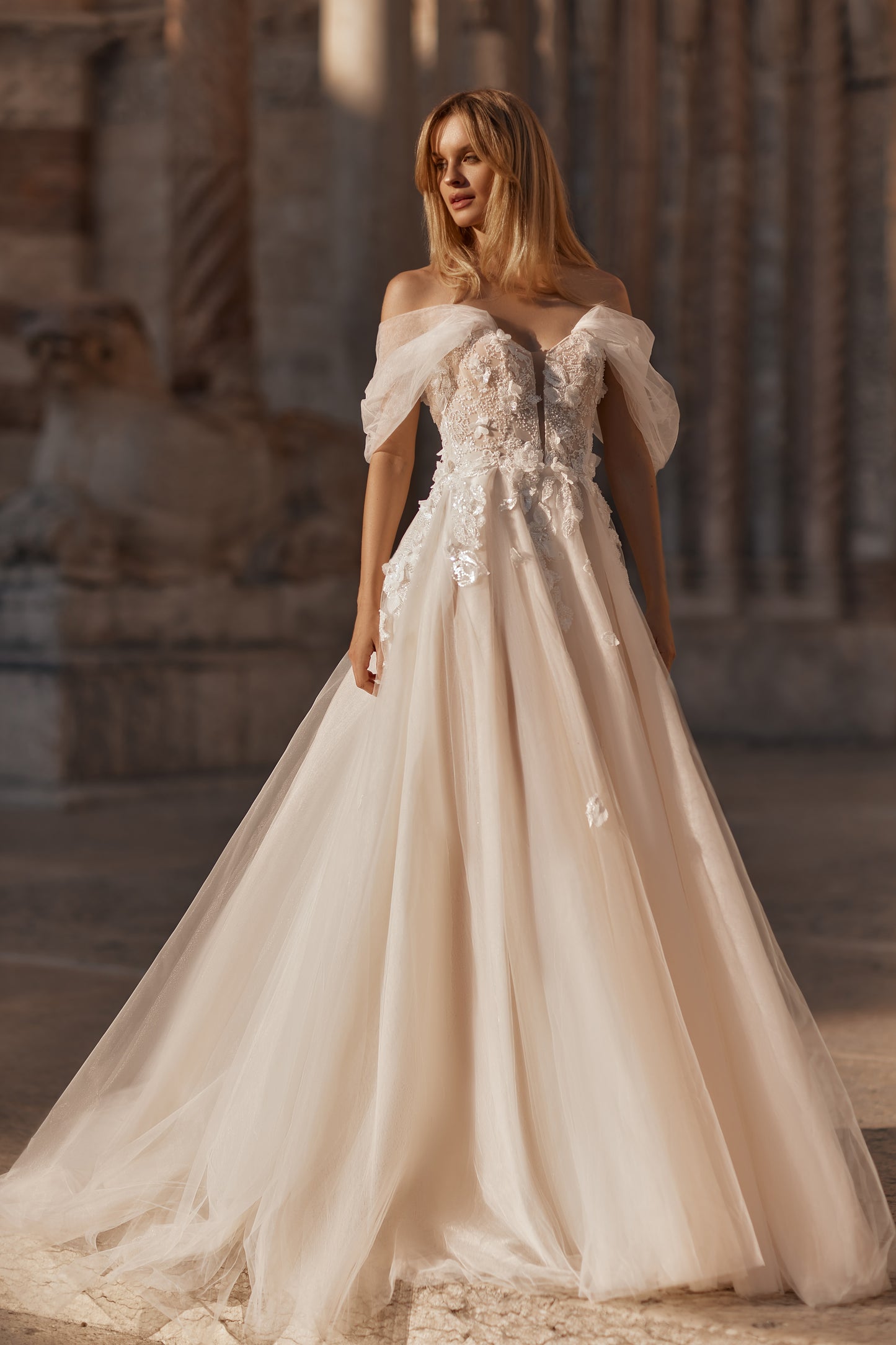 Flowing romantic gown with layered tulle skirt and intricate floral details