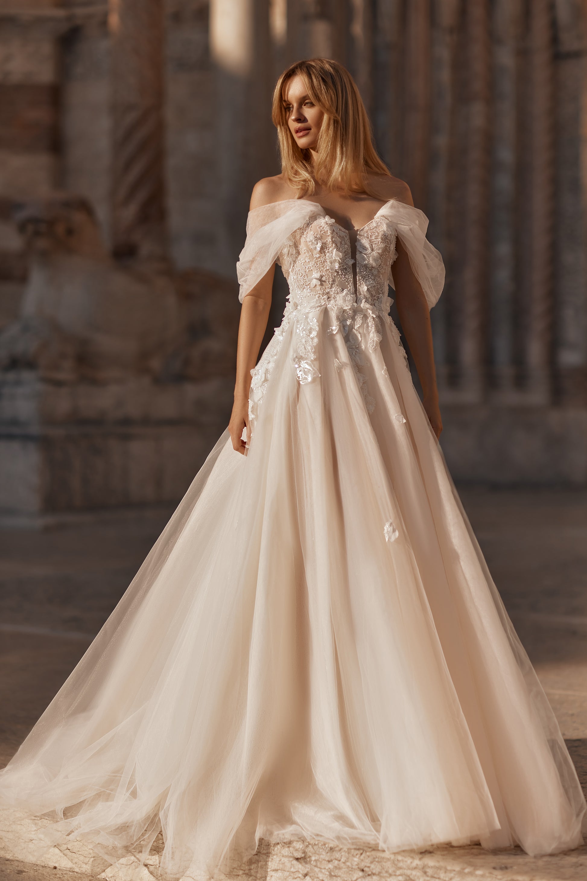 Flowing romantic gown with layered tulle skirt and intricate floral details
