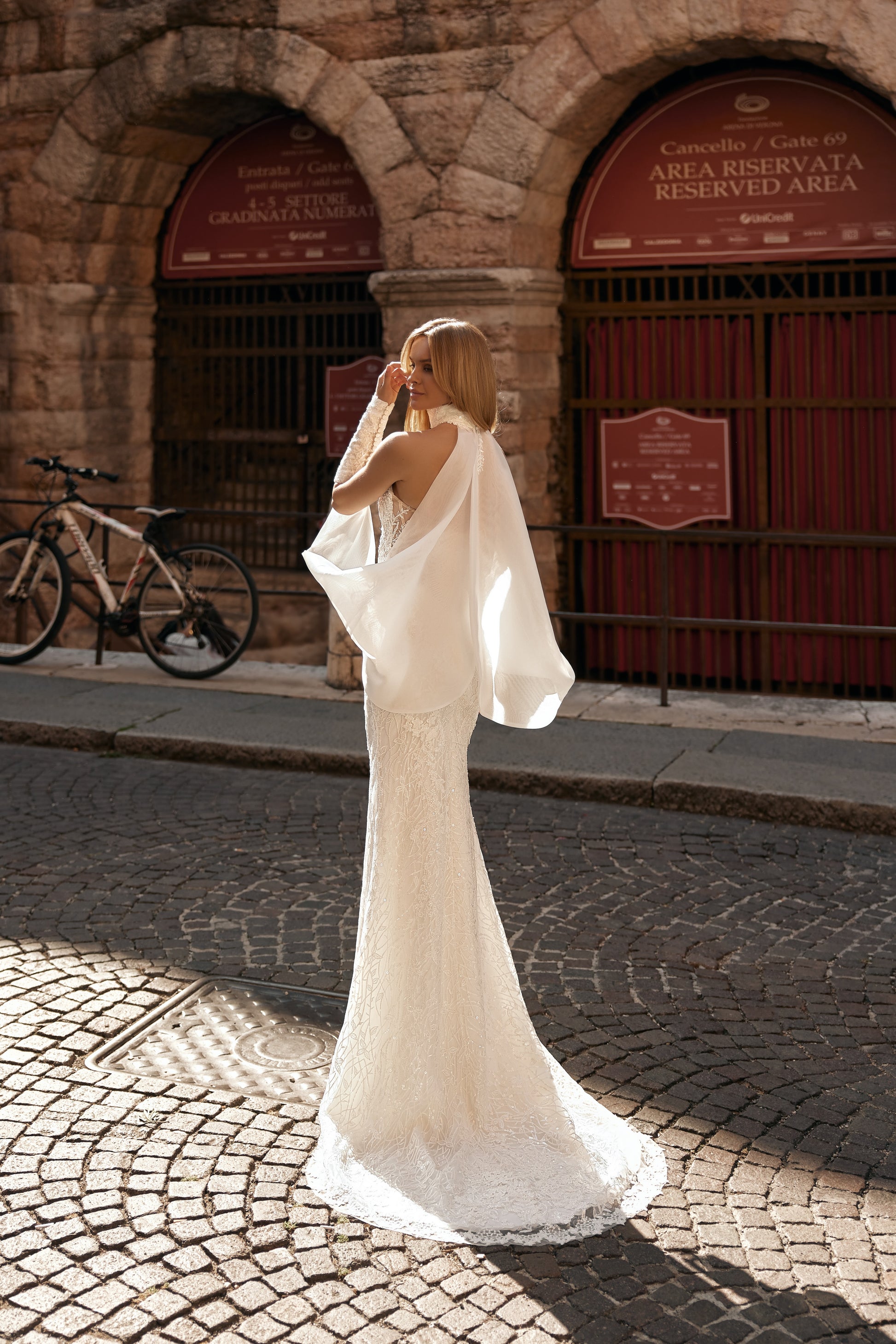Back view of the Massima wedding dress showing the delicate lace sleeves and attached choker design.