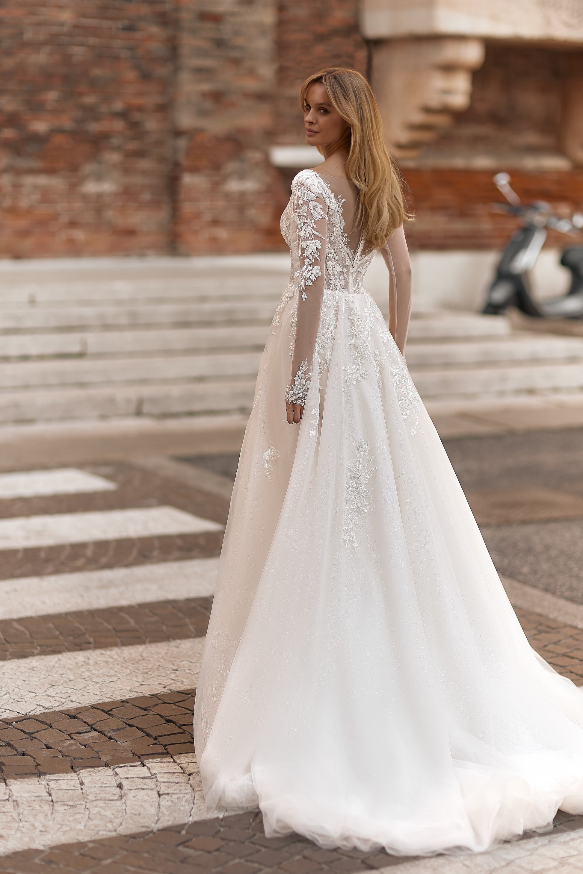 Romantic gown with a full tulle skirt, fitted bodice, and floral embroidery