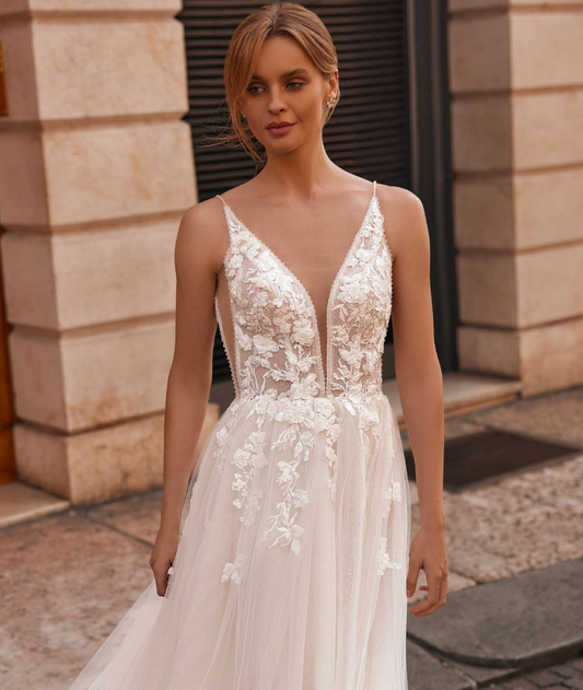 Bride in lightweight dress with floral lace top and thin shoulder straps