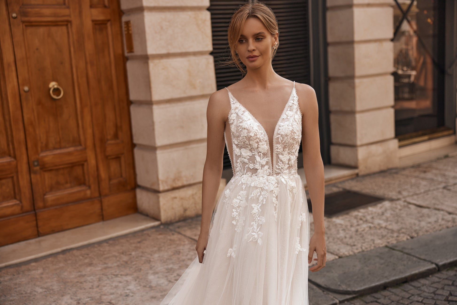 Bride in lightweight dress with floral lace top and thin shoulder straps