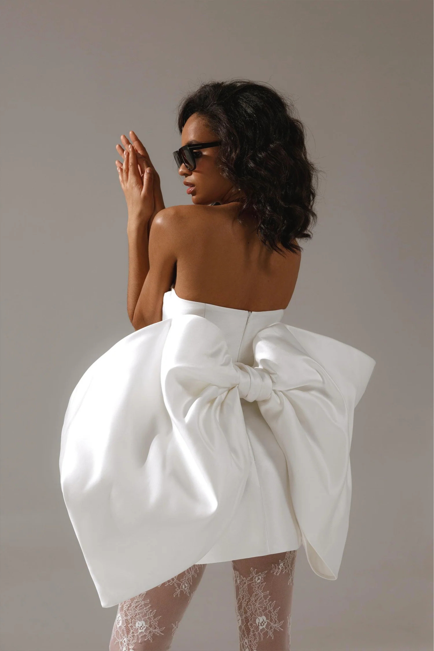 Ivory bridal mini dress with structured bodice and statement silhouette